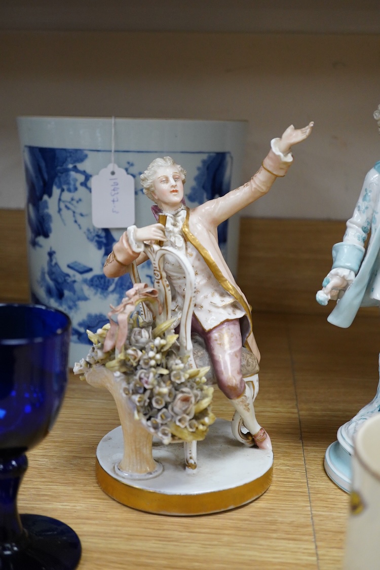 Sundry porcelain comprising three German figures, a Royal Worcester blush ivory ewer and a mug, together with a blue wine glass, largest 26cm high